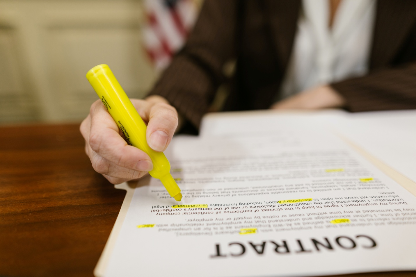 A person writing on a contract