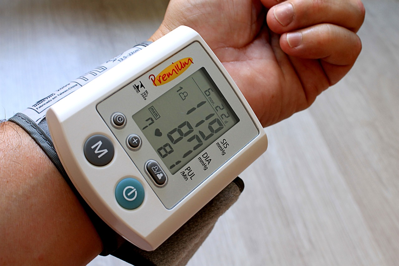  A person using a blood pressure monitoring machine