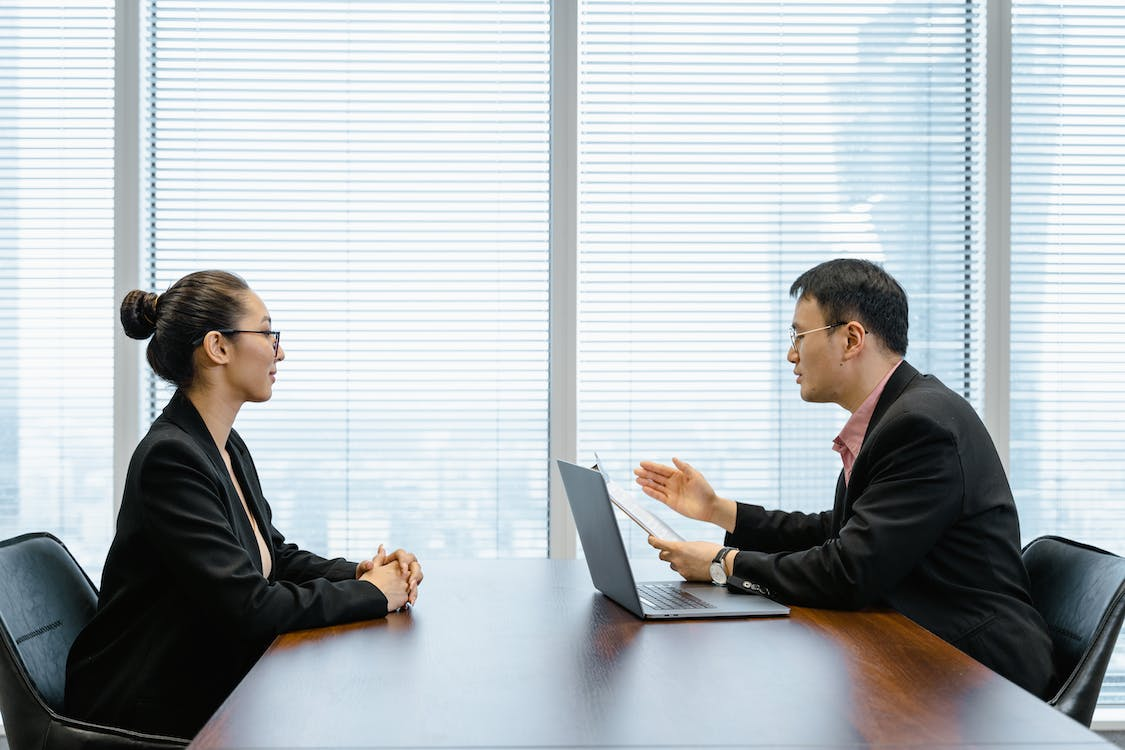 Businessman interviewing a businesswoman in an office