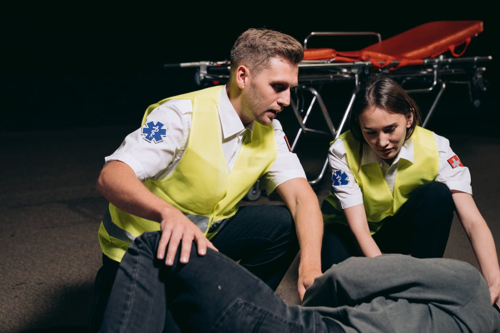 Two paramedics attending to an injured employee