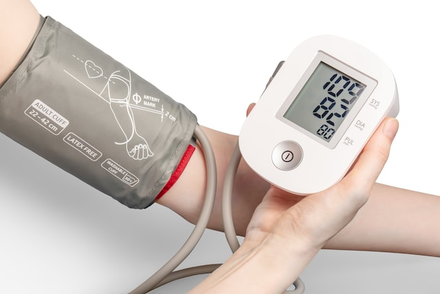 A person measuring their blood pressure.