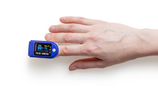A close-up of a finger pulse monitor.