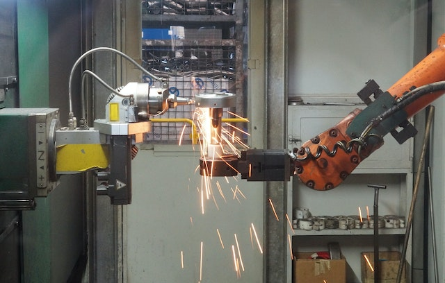 A robotic arm welding metal.